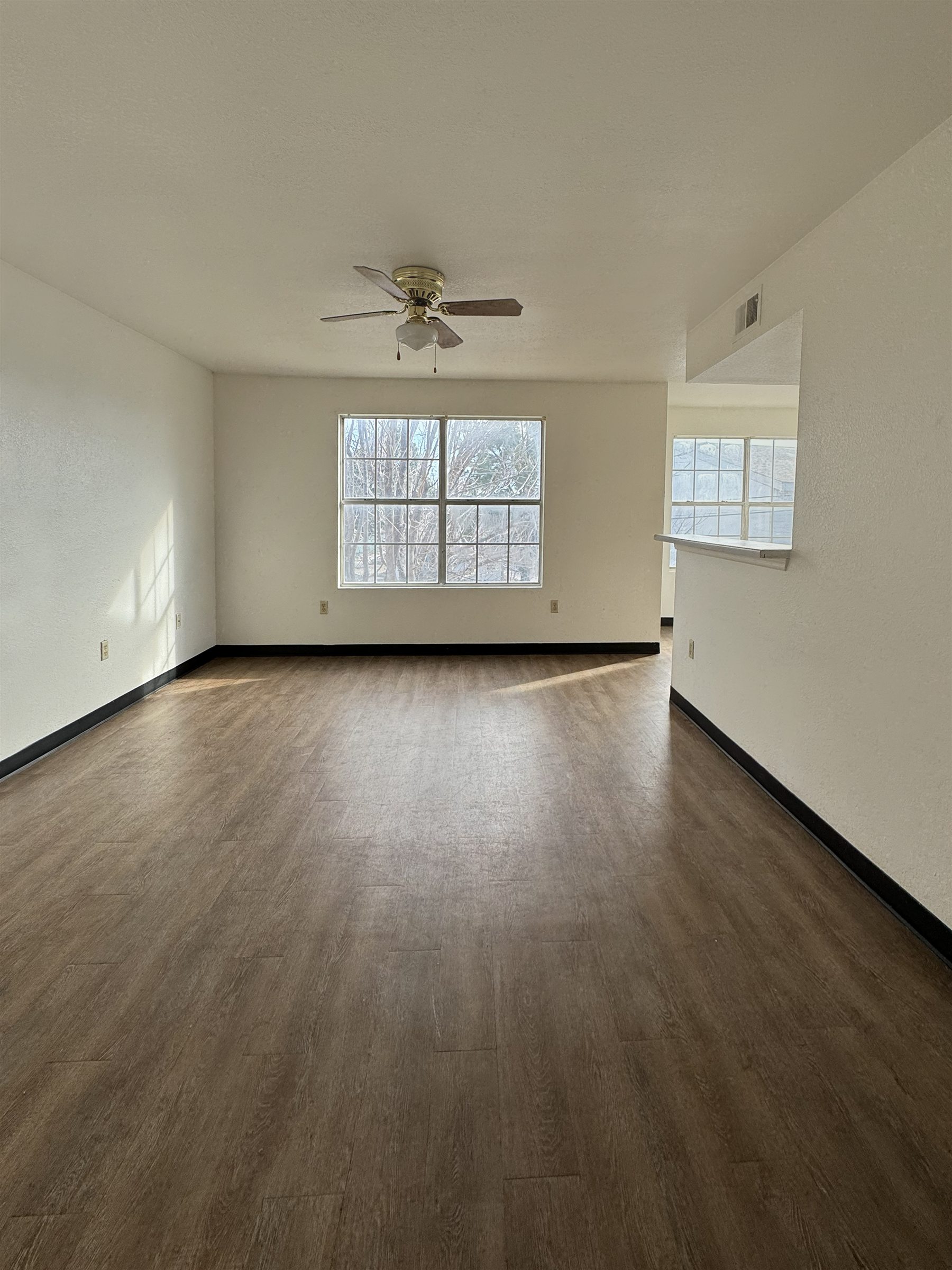 Living room with ceiling fan at Avalon Cove